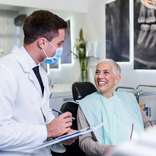 Orthodontist with mask talking to patient