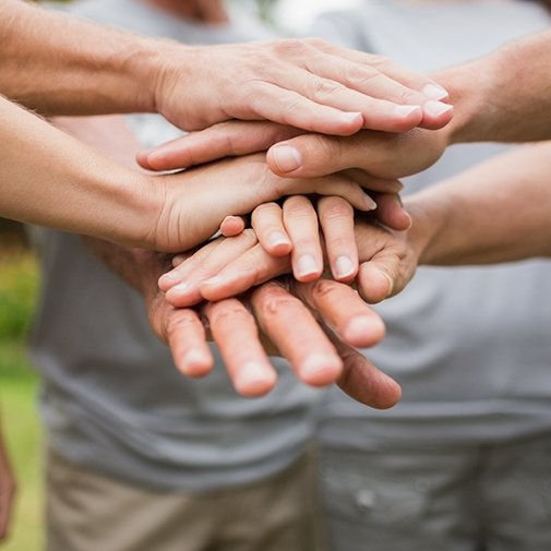 Close up of hands stacked up on top of each other