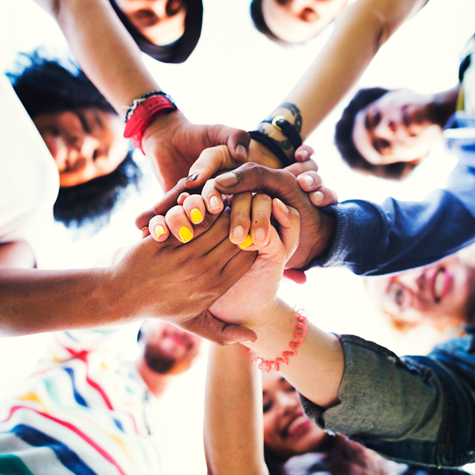 Group of people grasping hands