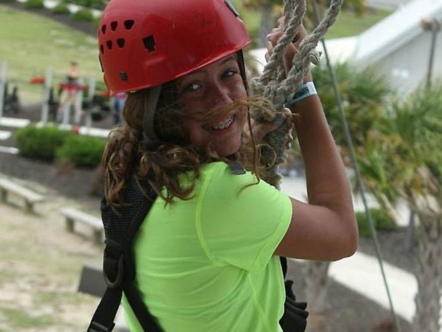 Woman with safety helmet about to ride rope