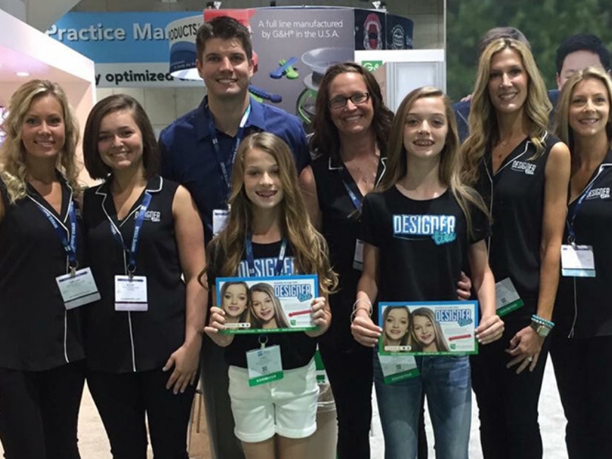 Orthodontic team standing together and holding signs