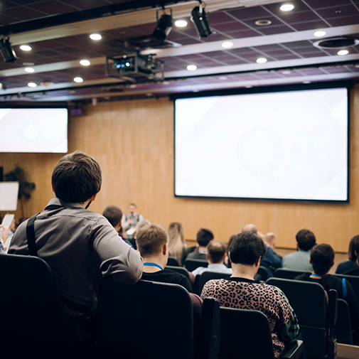 Students in lecture room looking at projection screen