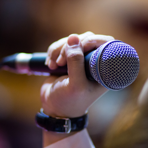 Close up of hand holding microphone