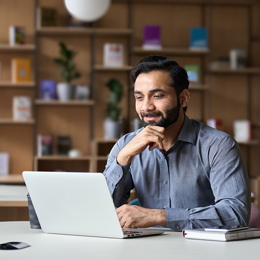 Man sitting and looking at laptop