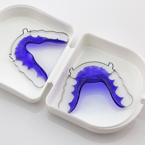 Two blue retainers in a case