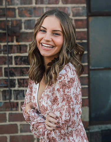 Woman in floral shirt smiling