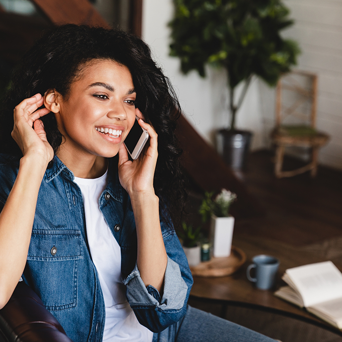 Woman in denim jacket talking on phone