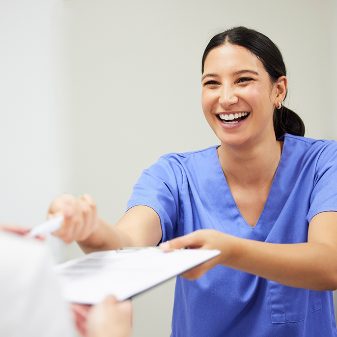 Orthodontist taking form on clipboard from patient